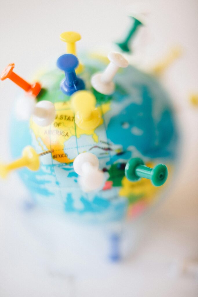 A vibrant globe with colorful pins marking destinations, symbolizing travel plans.